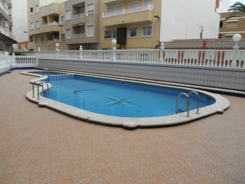 a swimming pool with a clock in the middle of a building at Apartment La Mata LM004 in La Mata
