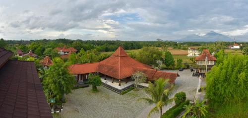 an aerial view of a house with a roof at Java Village Resort by HOMEE Yogyakarta in Yogyakarta