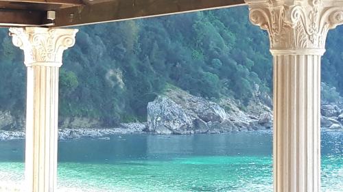 a view of a body of water through two columns at Castle Hotel in Himare