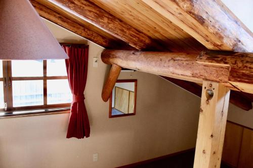a wooden beam on the ceiling of a room at Spa Lodge Redwood Inn in Takayama