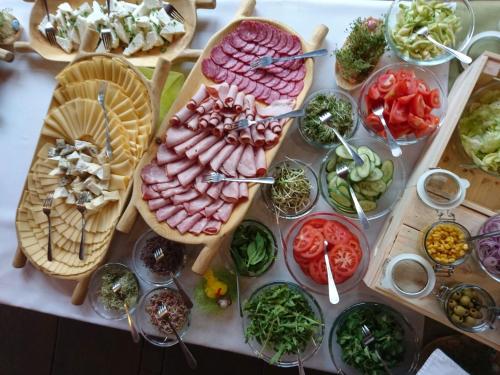 a table topped with lots of different types of food at Dolina Leśnicy SKI & SPA Resort in Brenna