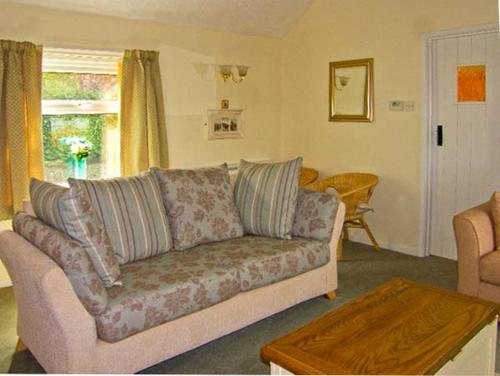 a living room with a couch and a table at Waterloo Cottage Annexe in Ruswarp