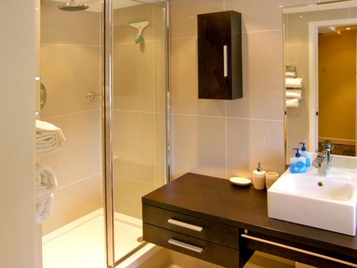 a bathroom with a sink and a shower at Howle Hideaway in Walford
