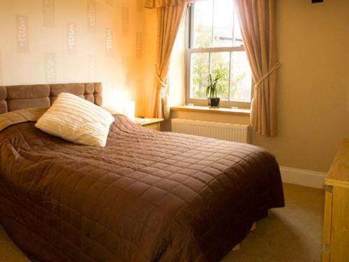 Ένα ή περισσότερα κρεβάτια σε δωμάτιο στο Briarcliffe Cottage