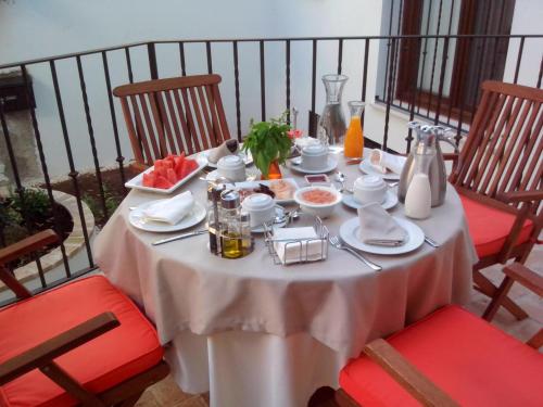 a table with a white table cloth on it at La Posada de Quijada in Granada