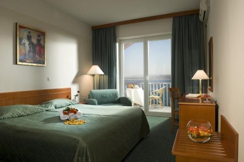 a hotel room with a bed and a balcony at Hotel Aquapark Žusterna in Koper