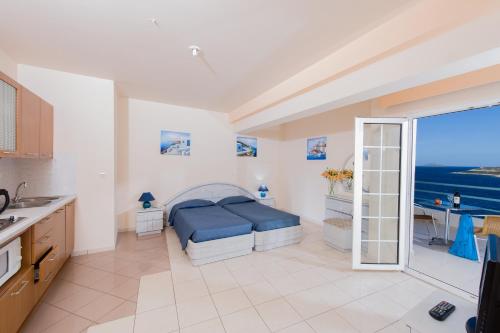 a bedroom with a bed and a view of the ocean at Creta Hotel in Agios Nikolaos