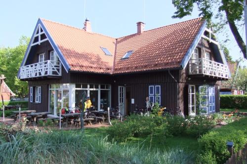 a house with a gambrel roof at Aika in Nida