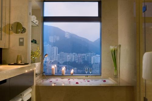 a bathroom with a window with candles in a bath tub at Crowne Plaza Hong Kong Causeway Bay by IHG in Hong Kong