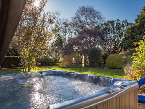 a large plunge pool in a yard with trees at Nairn in Braunton