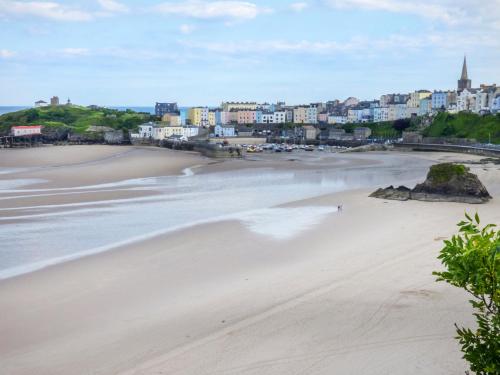 a view of a beach with a town in the background at North Beach at The Hideaway in Tenby