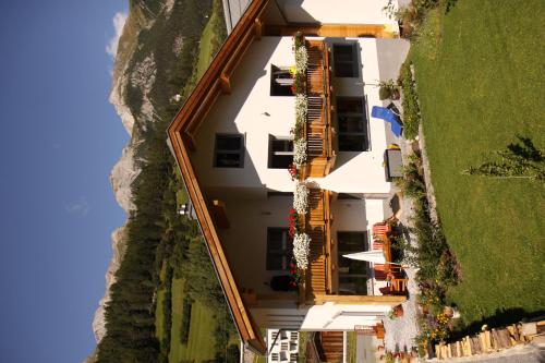 an aerial view of a white building on a hill at Ferienhaus Gundi in Pettneu am Arlberg
