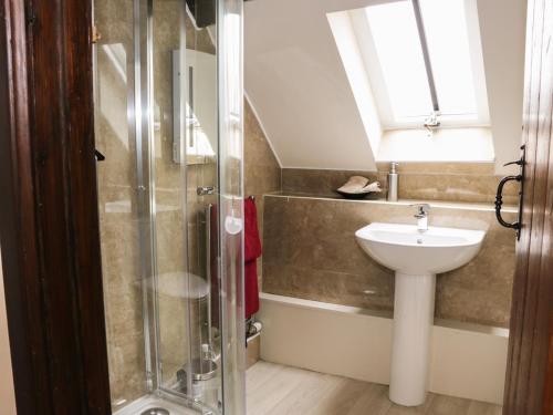 a bathroom with a shower and a sink at 7 Gretton in Cardington