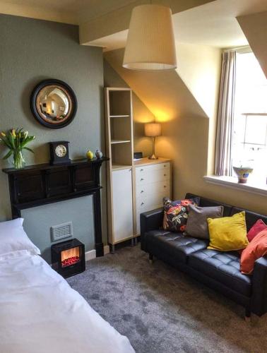 a bedroom with a bed and a couch and a mirror at The Feversham in York