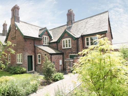 a brick house with a gambrel roof at Just A Cottage, Newlands Farm in Swanwick
