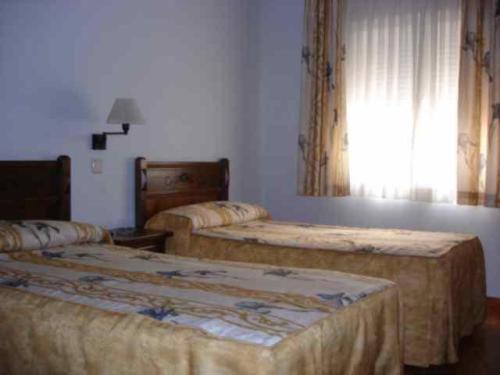 Cama o camas de una habitación en Hostal Cruz Verde