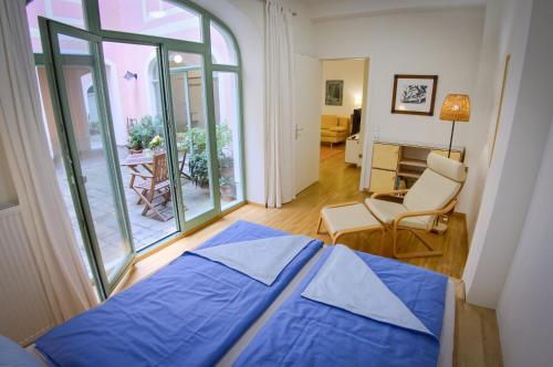 a bedroom with a blue bed and a living room at Fewo CANALETTO im Stadtzentrum in Dresden