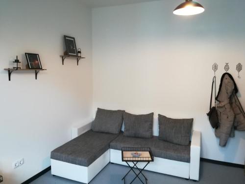 a living room with a couch and a table at Zentrales Apartment in Gelsenkirchen in Gelsenkirchen