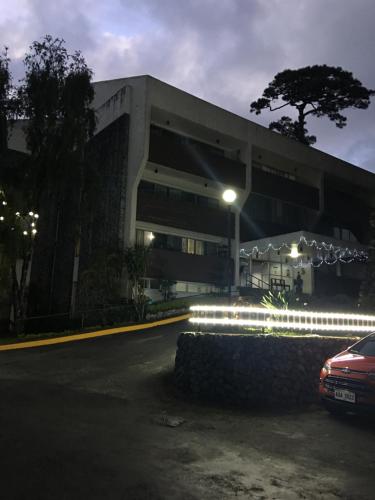 a building with a car parked in front of it at M&M Residence in Baguio