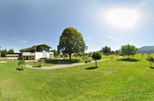 a park with a building in the middle of a field at Karglhof Stammhaus in Faak am See