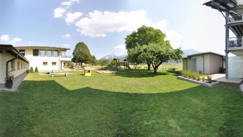 a large yard with a park with a playground at Karglhof Stammhaus in Faak am See