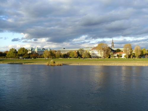 a large body of water with a city in the background at Fewo CANALETTO im Stadtzentrum in Dresden