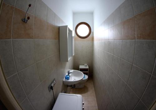 a small bathroom with a toilet and a sink at Residence Eden in Comacchio