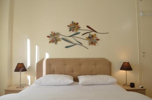 a bed with two pillows and a painting on the wall at Pedion Areos Park 6 Center 6 in Athens