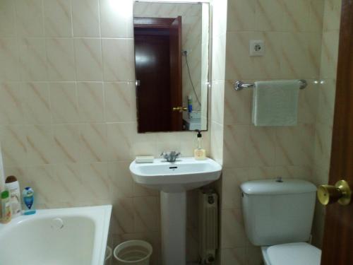 a bathroom with a sink and a toilet and a mirror at Apartamento Salou, playas, piscina in Salou