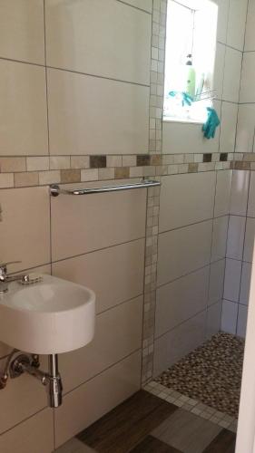 a bathroom with a sink and a window at Moye Guest House in Benoni