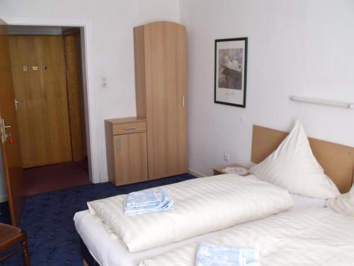 Postel nebo postele na pokoji v ubytování Hotel Am Kamin