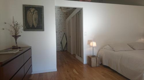 a bedroom with a bed and a table with a lamp at Mazet Des Artistes in Mouriès