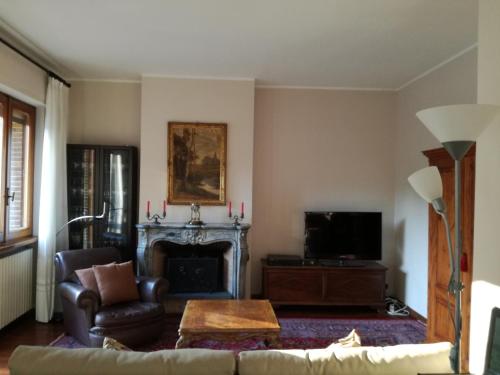 a living room with a couch and a fireplace at Gerry Home in Valmadrera