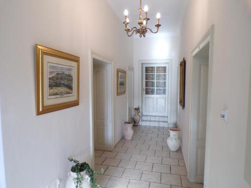 a hallway with a bathroom with a chandelier at Gästehaus Residenz Lapeiner in Pörtschach am Wörthersee