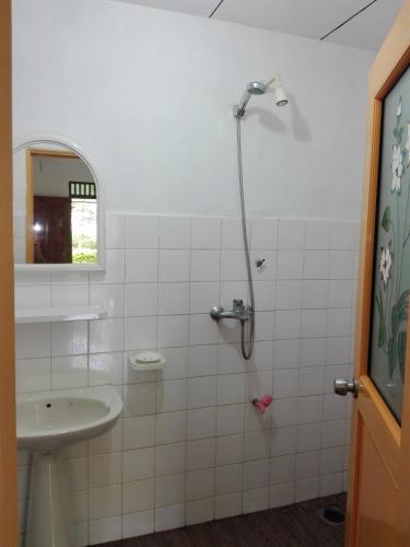 a bathroom with a shower and a sink at Calm Garden Cabanas in Tangalle
