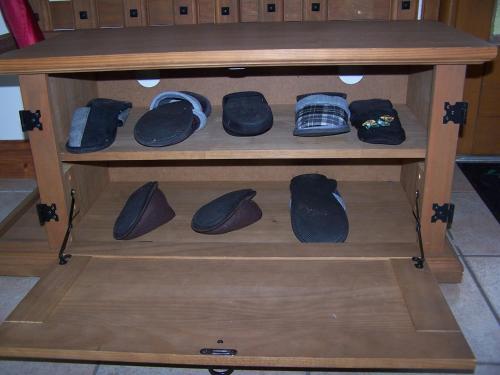 a wooden shelf with a bunch of shoes on it at Gite en Forterre in Druyes-les-Belles-Fontaines