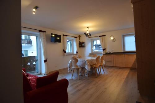 a kitchen and dining room with a table and chairs at Vajolet in Campitello di Fassa