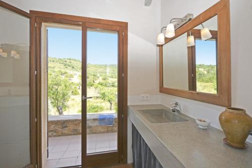 a bathroom with a sink and a mirror and a window at Villa Font in Artá
