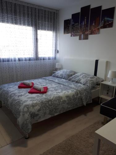 a bedroom with a bed with red towels on it at Studio Apartman Marija in Zagreb