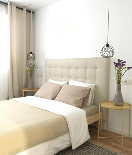 a bedroom with a large white bed and two tables at Apartment Santa Teresa in Altea