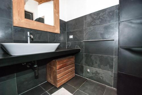 a bathroom with a sink and a mirror at Luxury Seaview Apartments Manarola by Arbaspàa in Manarola