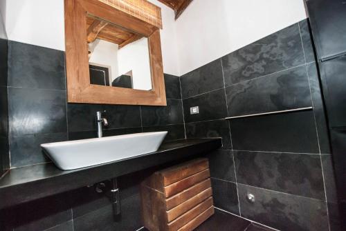 a bathroom with a sink and a mirror at Luxury Seaview Apartments Manarola by Arbaspàa in Manarola