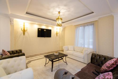 a living room with a couch and a table at Orchid Boutique Hotel in Tbilisi City