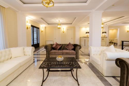 a living room with couches and a coffee table at Orchid Boutique Hotel in Tbilisi City