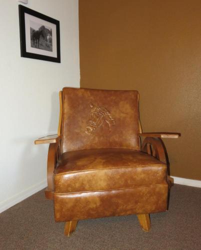 a brown leather chair sitting in a room at Raton Pass Motor Inn in Raton