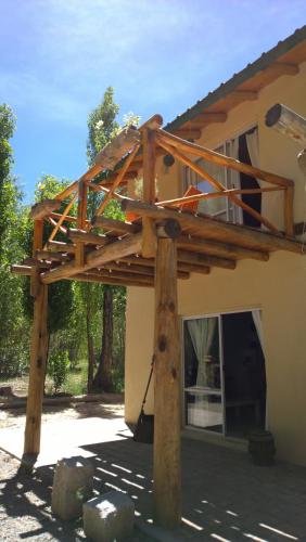 a wooden pergola on top of a house at Balcon de Antares in Uspallata