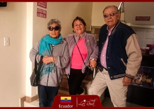 a group of three older people posing for a picture at Hostal La Rosa Otavalo in Otavalo