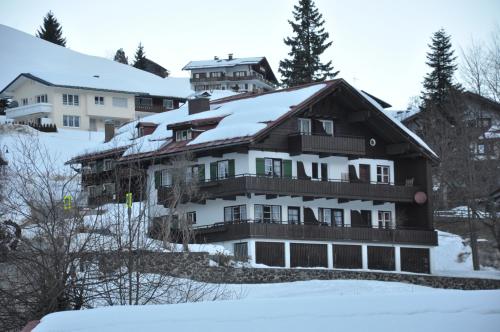 a house with snow on top of it at Herzen´s Landhaus in Hirschegg