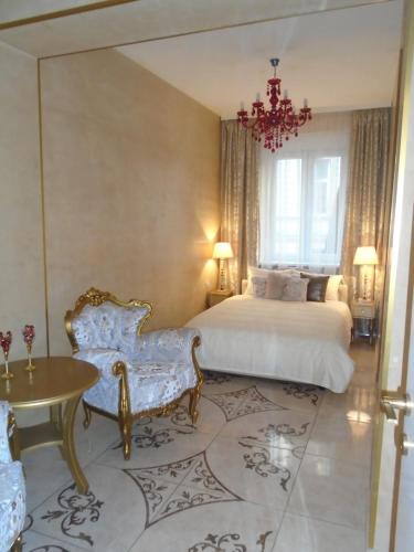 Un dormitorio con una cama y una mesa y sillas. en Apartment Bourgeois, en Belgrado