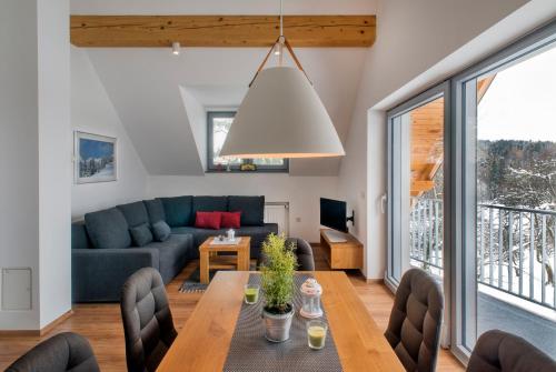 a living room with a couch and a table at Apartments Sivka - Private Sauna in Cerklje na Gorenjskem